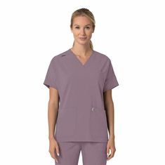 Step into your workday with confidence in the Carhartt Women's Oversized V-Neck Scrub Top. Engineered for healthcare professionals, this scrub top combines style and functionality. The curved V-neck with slim binding and a shoulder badge loop adds a touch of sophistication, while the vented yoke ensures breathability during long shifts. Practicality meets convenience with features like a welt chest pocket, two front top load pockets, a mesh cellphone pocket, and a pen slot. The racerback detail Lavender Mist, Dobby Fabric, Carhartt Womens, Oversized Top, Professional Look, Pocket Bag, Box Pleats, Scrub Tops, Healthcare Professionals