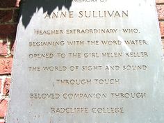 a plaque on the side of a brick building that reads,'memory of anne sulllivan teacher extraordinary who beginning with the word water opened to the girl helen kells