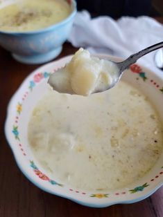 a spoon full of soup on top of a plate