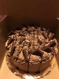 a large chocolate cake in a box on a table