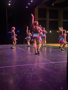 a group of dancers performing on stage