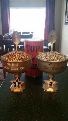 two bowls filled with food sitting on top of a counter