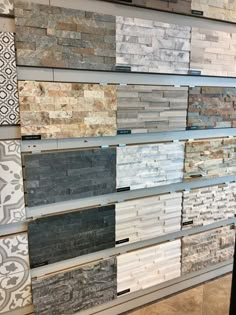 tile samples are displayed on the wall in this store, with different colors and patterns