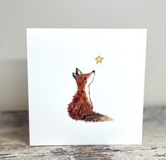 a card with a drawing of a fox and a star on it's head