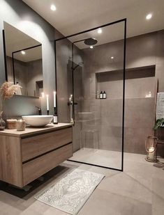 a bathroom with a sink, mirror and shower stall in the middle of the room