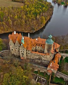 an aerial view of a castle surrounded by trees