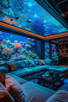 a living room filled with lots of furniture and a large fish tank in the ceiling