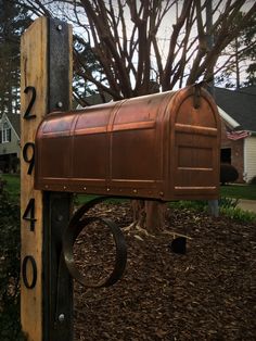 a mailbox is attached to a wooden post