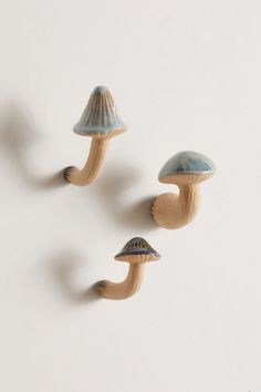 three ceramic mushrooms on a white background