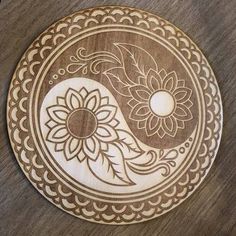 a wooden plate with a yin - yang design on it