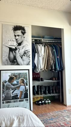 there is a closet with clothes and pictures on the wall