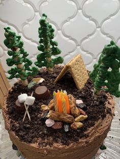 a cake decorated with trees, rocks and candy