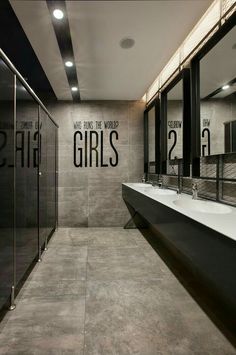 a bathroom with two sinks and mirrors on the wall