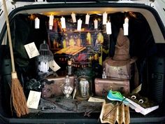 a trunk filled with lots of luggage and candles