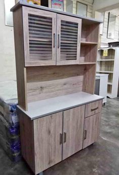 a wooden cabinet sitting in the middle of a room