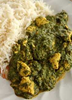 a white plate topped with rice and green sauce