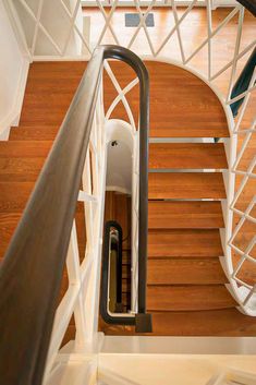 an overhead view of a wooden staircase with metal handrails