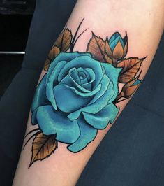 a blue rose tattoo on the arm