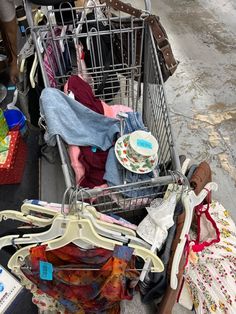 a shopping cart filled with clothes and other items