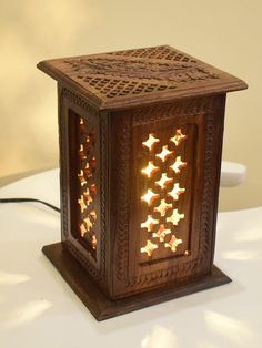 a small wooden lantern with stars on it