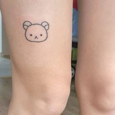 two people with tattoos on their legs, one has a bear face and the other has a cat's head