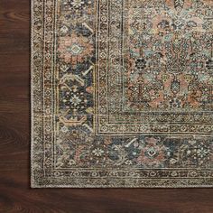 an antique persian rug is shown on a wooden floor with dark wood floors and brown walls