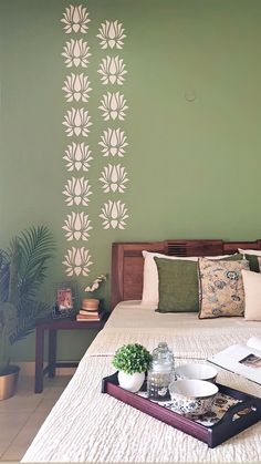 a bed room with a neatly made bed and a tray on top of the bed