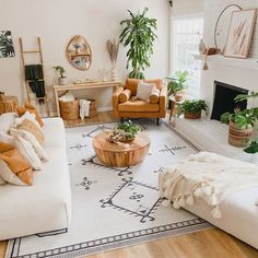 a living room filled with furniture and plants