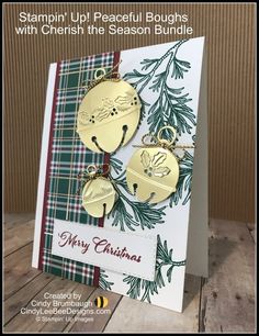 a christmas card with two gold ornaments on it