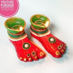 pair of red shoes with green and gold decorations