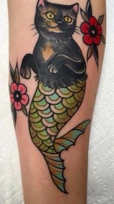 a black cat sitting on top of a fish with flowers in it's tail