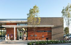 two people walking into the entrance of a library