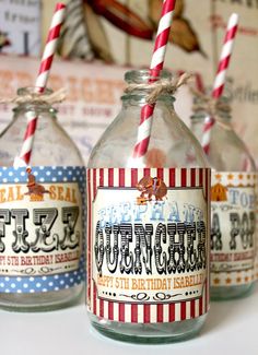 three glass jars with striped paper straws in them