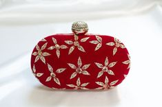 Red Clutch Designer made for Weddings w/ Minimal Zardozi Minimal clutch adorned with simple floral zardozi, bead & sequin embellishments. This red clutch purse evening -wear with a stone-studded closure at the top is a must-have in your wardrobe - a versatile accessory for any party outfit!  Lining: Fabric Color: Red Embroidery: Zardozi, Sequin & Bead Size & Dimensions:  Height - 5 in Width - 8 in Depth - 1.5 in Fits most of the phones. Strap: Detachable shoulder metal chain strap  Closure: Comp Traditional Red Party Bag, Red Luxury Bag For Festive Season, Luxury Red Bags For Festive Season, Traditional Rectangular Coin Purse For Evening, Traditional Red Festive Evening Bag, Designer Embellished Wedding Clutch, Elegant Red Festive Bag, Designer Embellished Clutch For Wedding, Formal Red Embroidered Bag