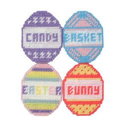 three cross stitch coasters with the words candy and gummy written on each one