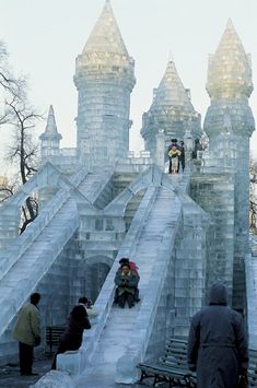 people are walking up and down an ice castle