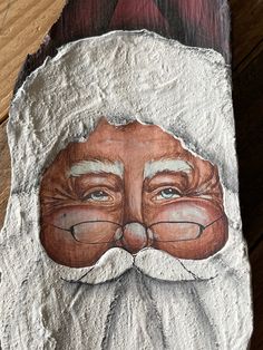 a close up of a piece of paper with a painting on it's face