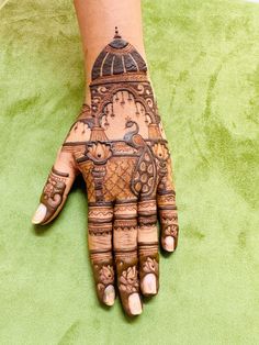 a woman's hand with henna tattoos on it