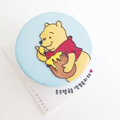 a winnie the pooh brooch sitting on top of a piece of paper