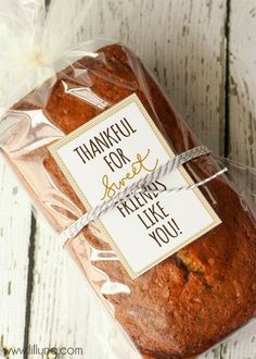 a loaf of bread wrapped in plastic with a thank you sign attached to the side