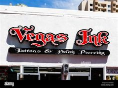 the front of a tattoo and body piercing shop with large red letters on it's sign