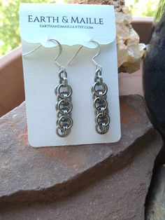 Stainless steel Helm chain weave earrings.  They measure approx. 1.25 inches long and have a hypo-allergenic fish hook.  Cleaning Stainless steel is easy to clean with warm, soapy water. The copper rings will tarnish and become darker over time. You can make the copper and stainless steel shine like new using a metal polish (like Noxon or Brasso). Avoid using the metal polish on any stones. Don't hesitate to contact us with any questions you may have Nickel-free Chain Link Jewelry In Stainless Steel, Nickel-free Stainless Steel Chain Link Jewelry, Chain Link Metal Earrings For Gift, Metal Chain Link Earrings For Gifts, Hypoallergenic Stainless Steel Chain Link Jewelry, Hypoallergenic Dangle Earrings In Stainless Steel, Handmade Gunmetal Stainless Steel Jewelry, Handmade Stainless Steel Gunmetal Jewelry, Gunmetal Metal Earrings Gift