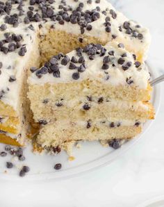 a cake with white frosting and chocolate chips on top