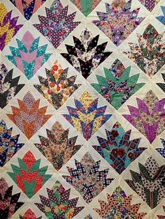 a colorful quilt with many different designs on it