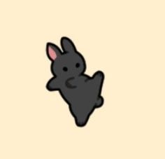 a black rabbit is sitting on its hind legs