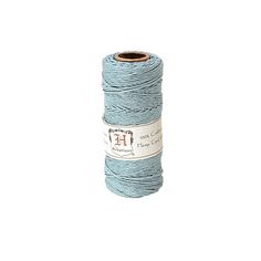 a spool of blue yarn on a white background