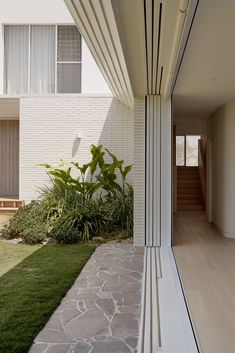 an outside view of a house with grass and plants