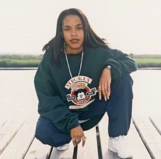 a woman sitting on top of a wooden dock