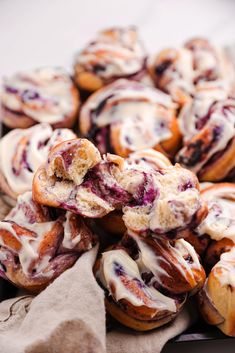 a bunch of doughnuts that are sitting on a table with some napkins