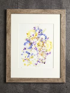 an art work with watercolors on paper in a wooden frame hanging on the wall